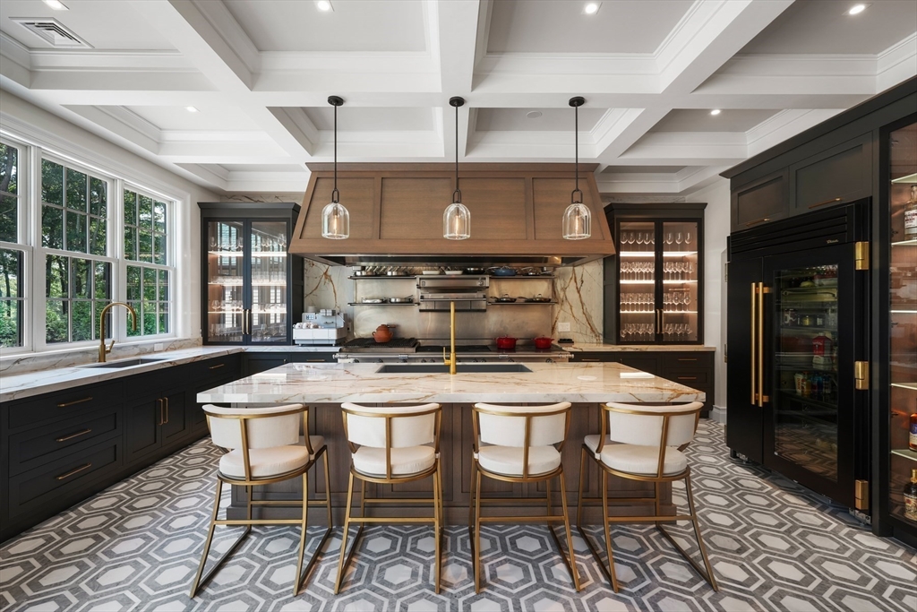 a kitchen with a dining table chairs and white cabinets