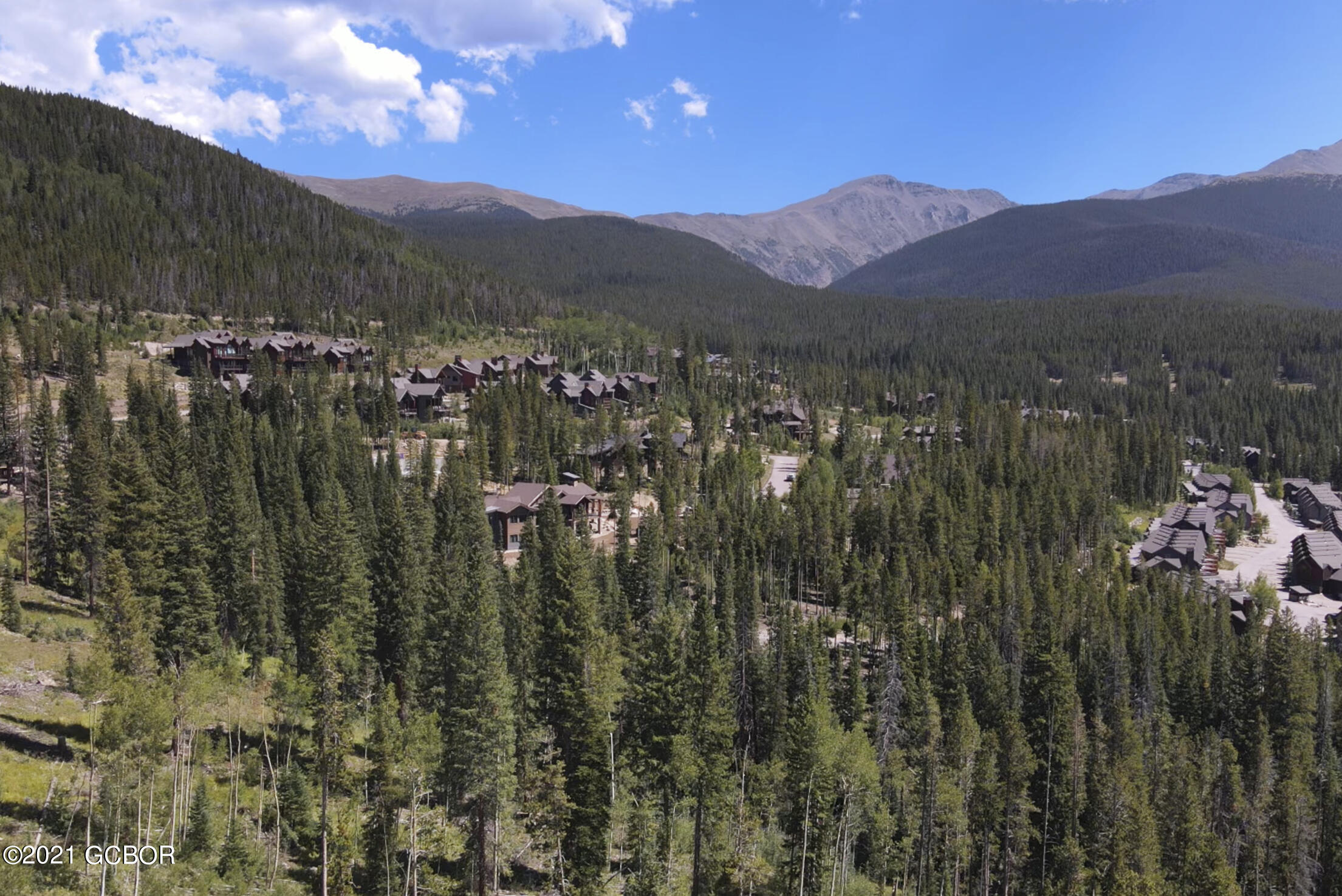 a view of a town with mountains in the background