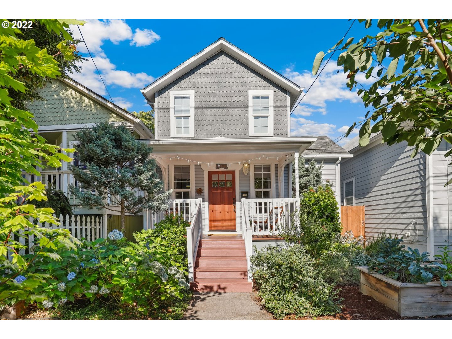 a front view of a house with a garden