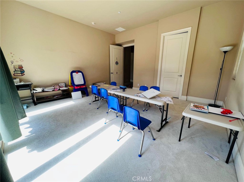 a reading room with furniture and rug