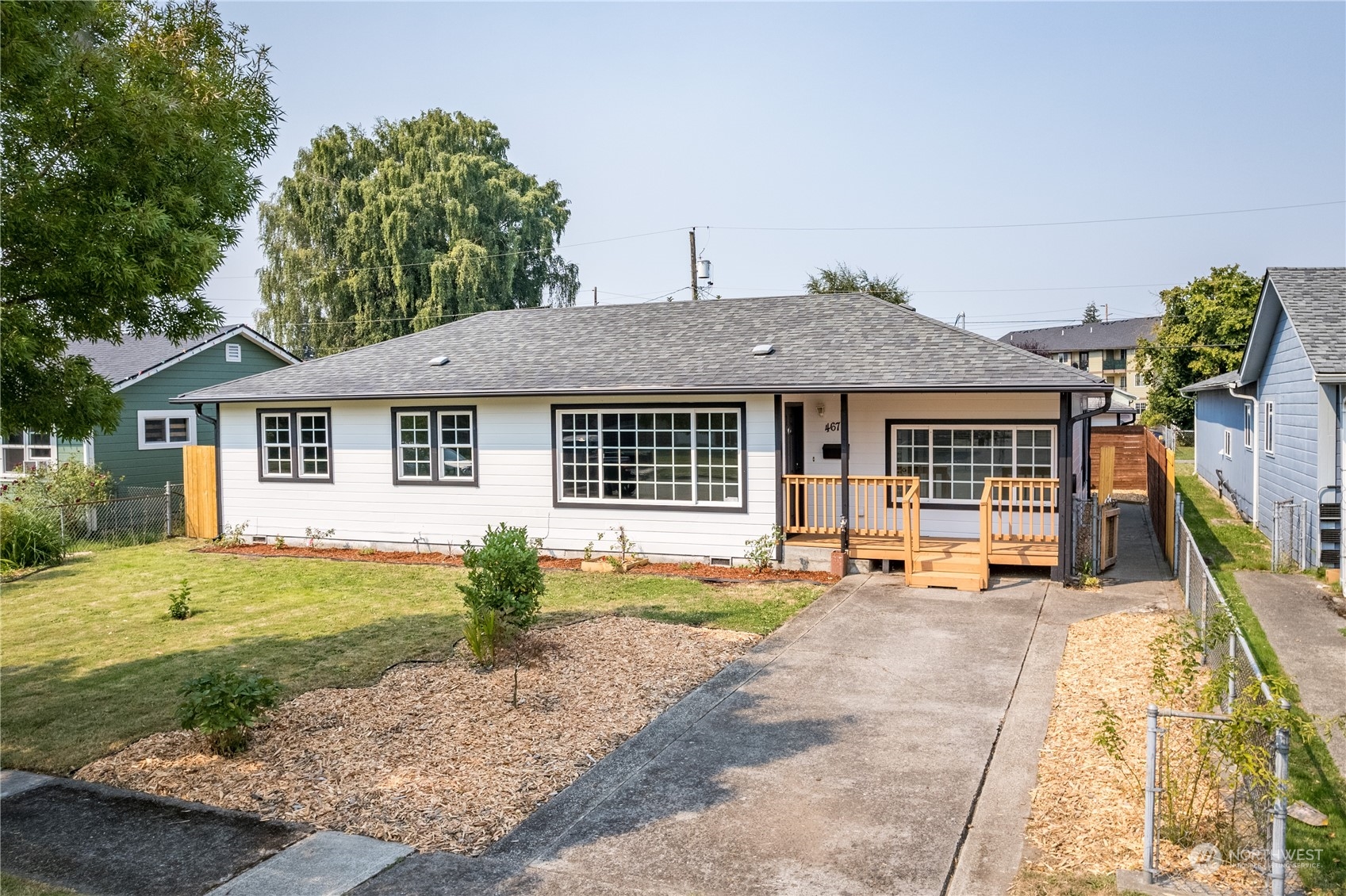 a front view of a house with a yard and seating space