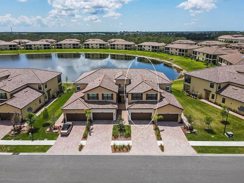 an aerial view of a house with a lake view