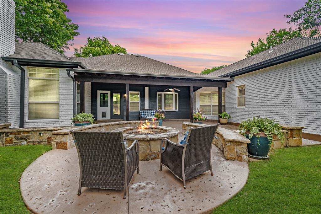 a view of a house with backyard sitting area and garden