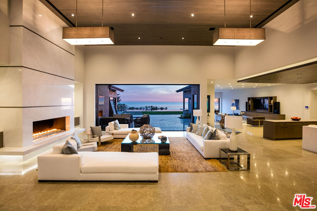 a living room with fireplace furniture and a flat screen tv