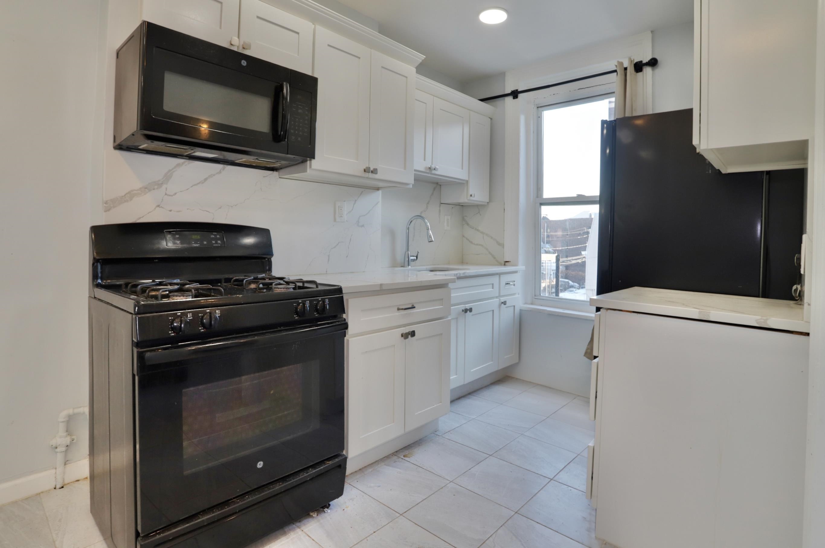 a kitchen with cabinets stainless steel appliances and a sink