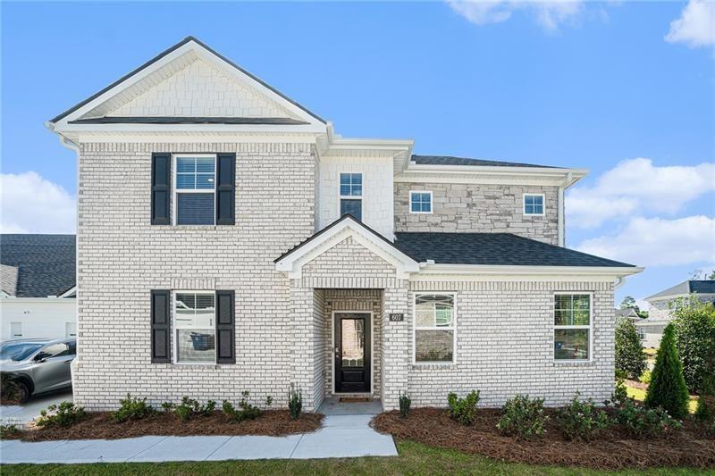 a front view of a house with a yard