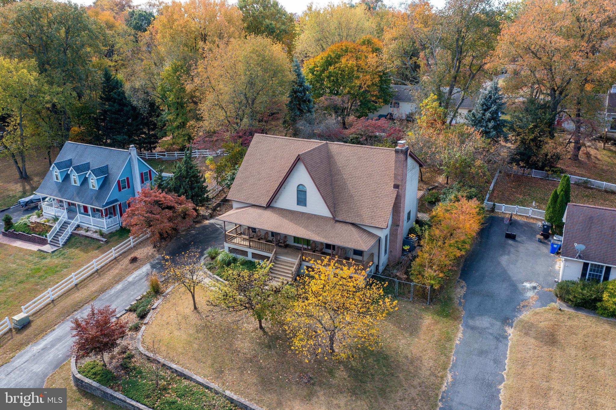 an aerial view of a house with a yard basket ball court and outdoor seating