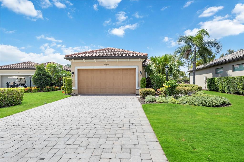 a front view of a house with a yard and garage