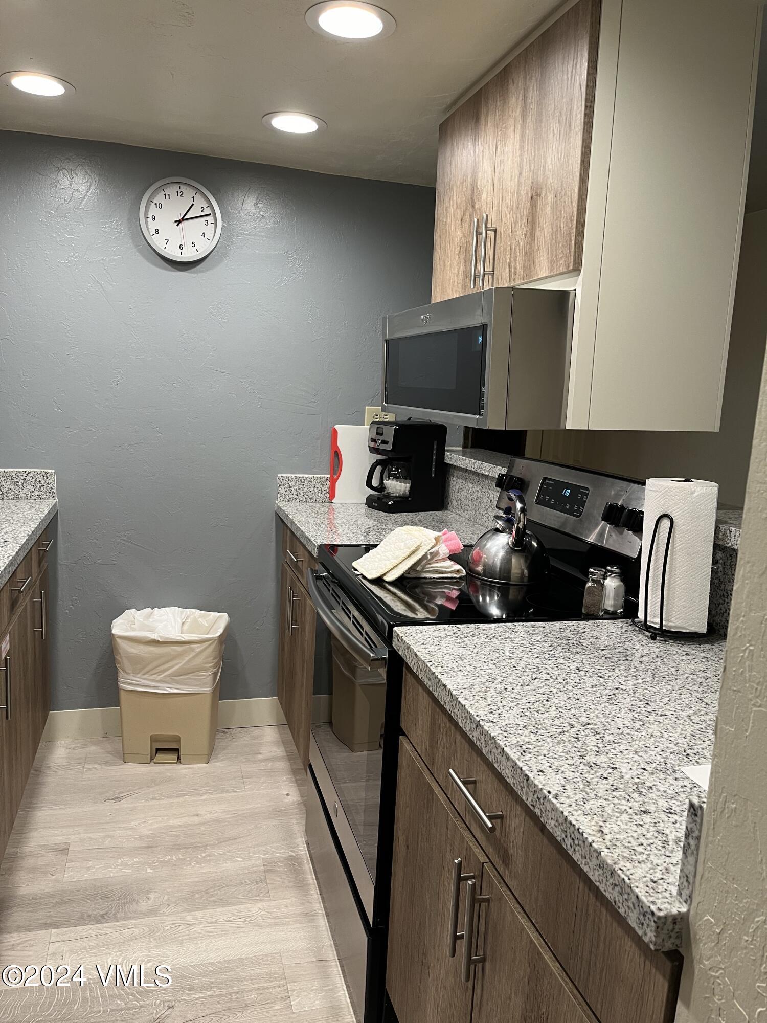 a kitchen with a sink appliances and cabinets