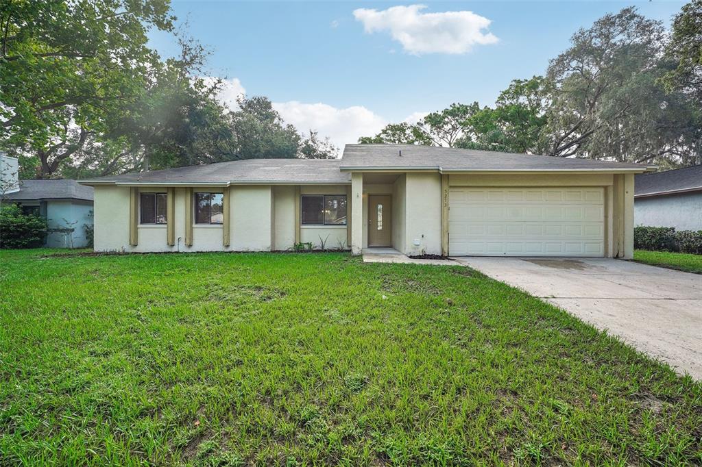 a view of a house with yard and tree s