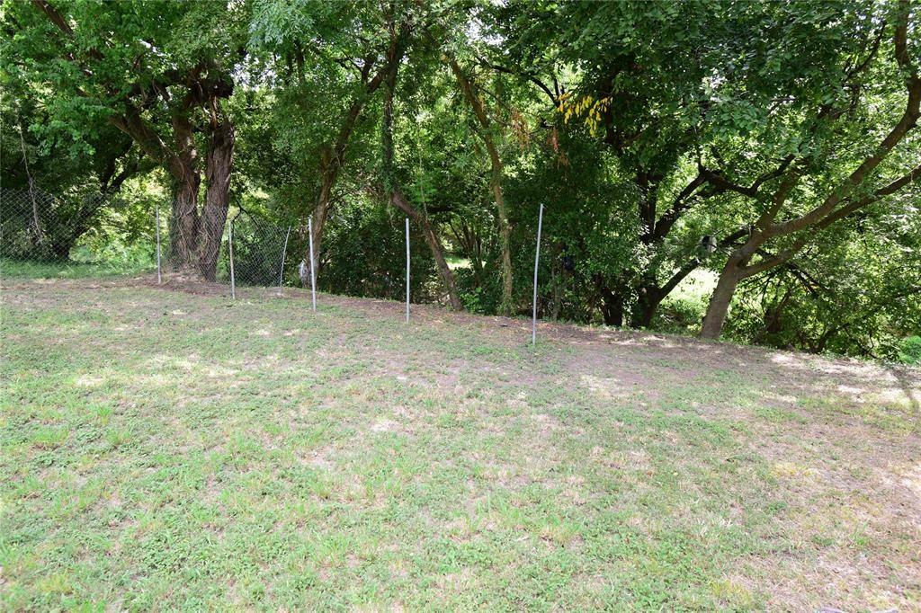 a view of empty room with trees in the background