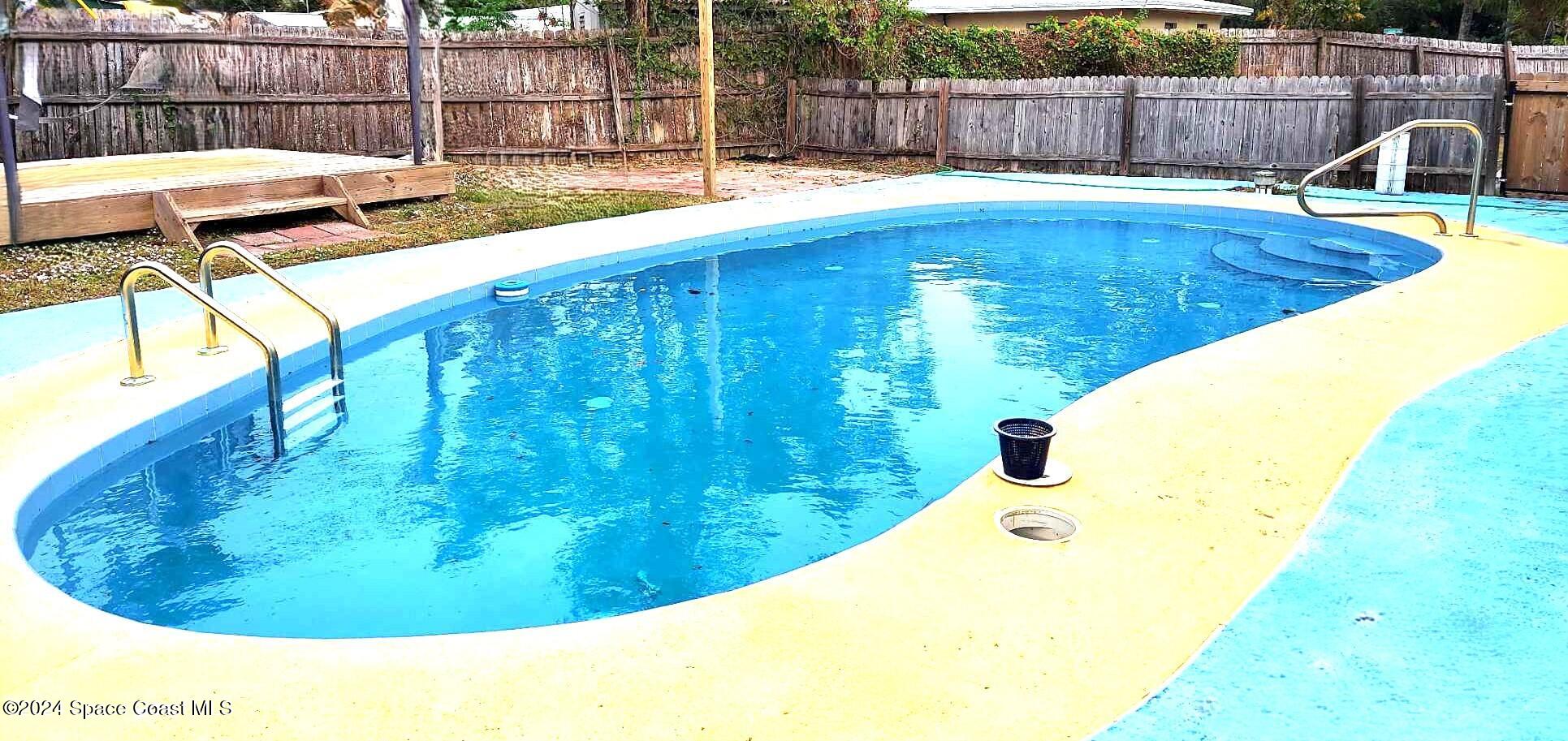 a view of a swimming pool with a patio