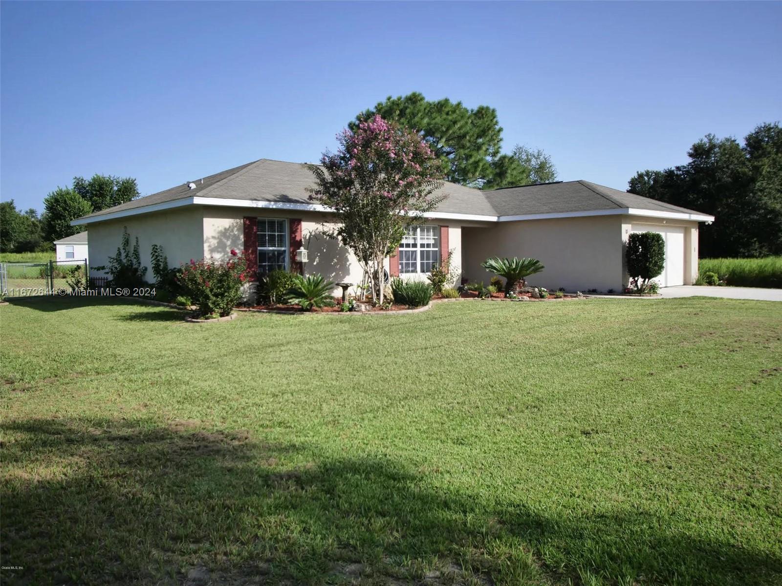 a view of a house with a yard and sitting area