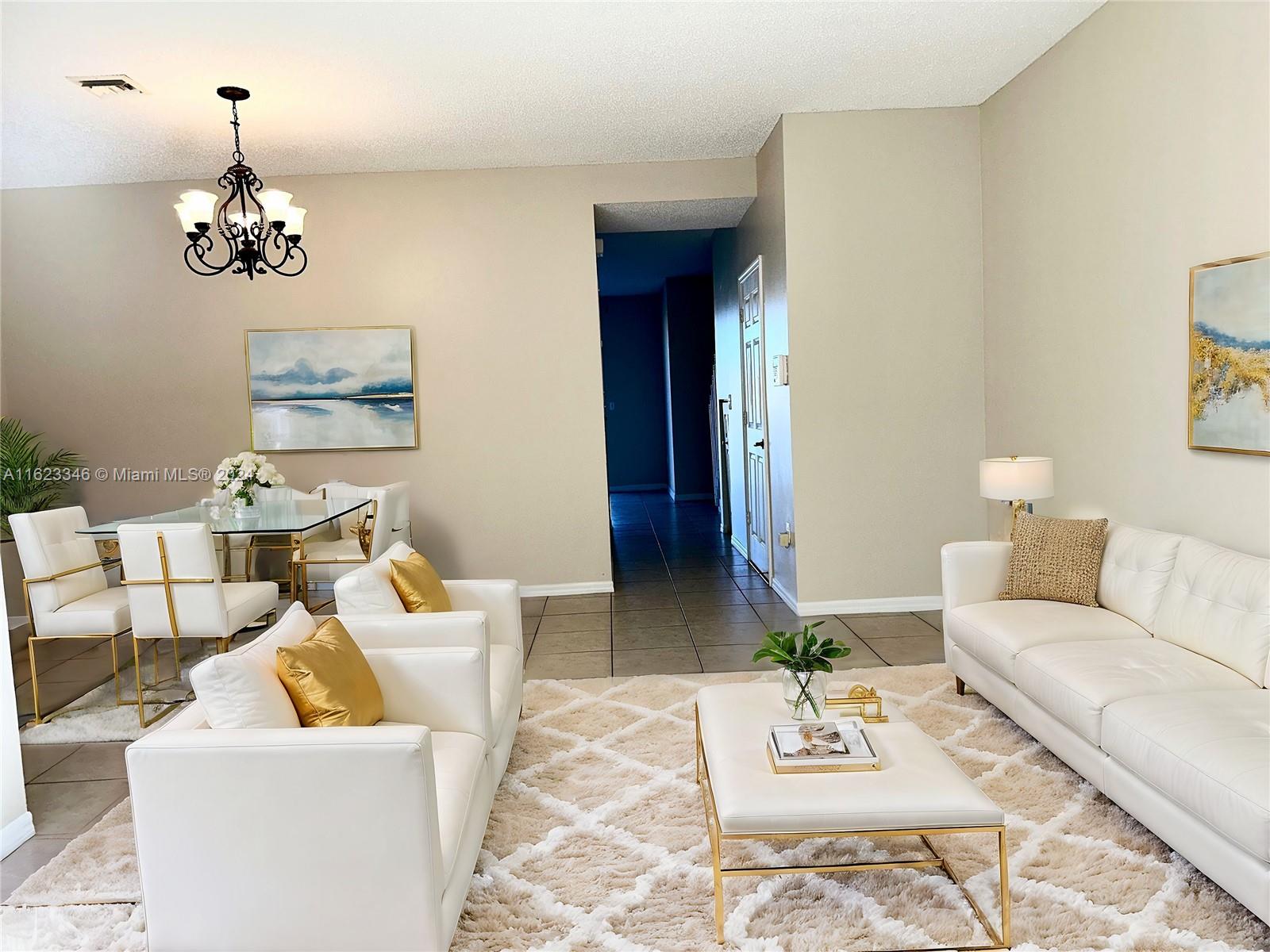 a living room with furniture a rug and a table