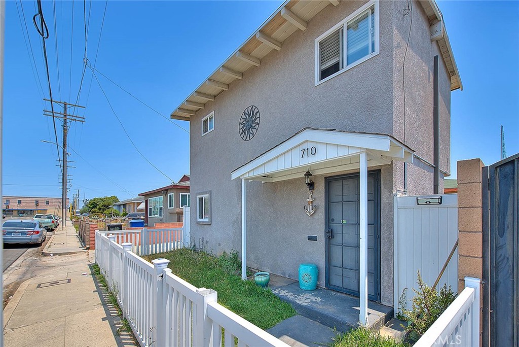 a view of a house with many windows and a fence