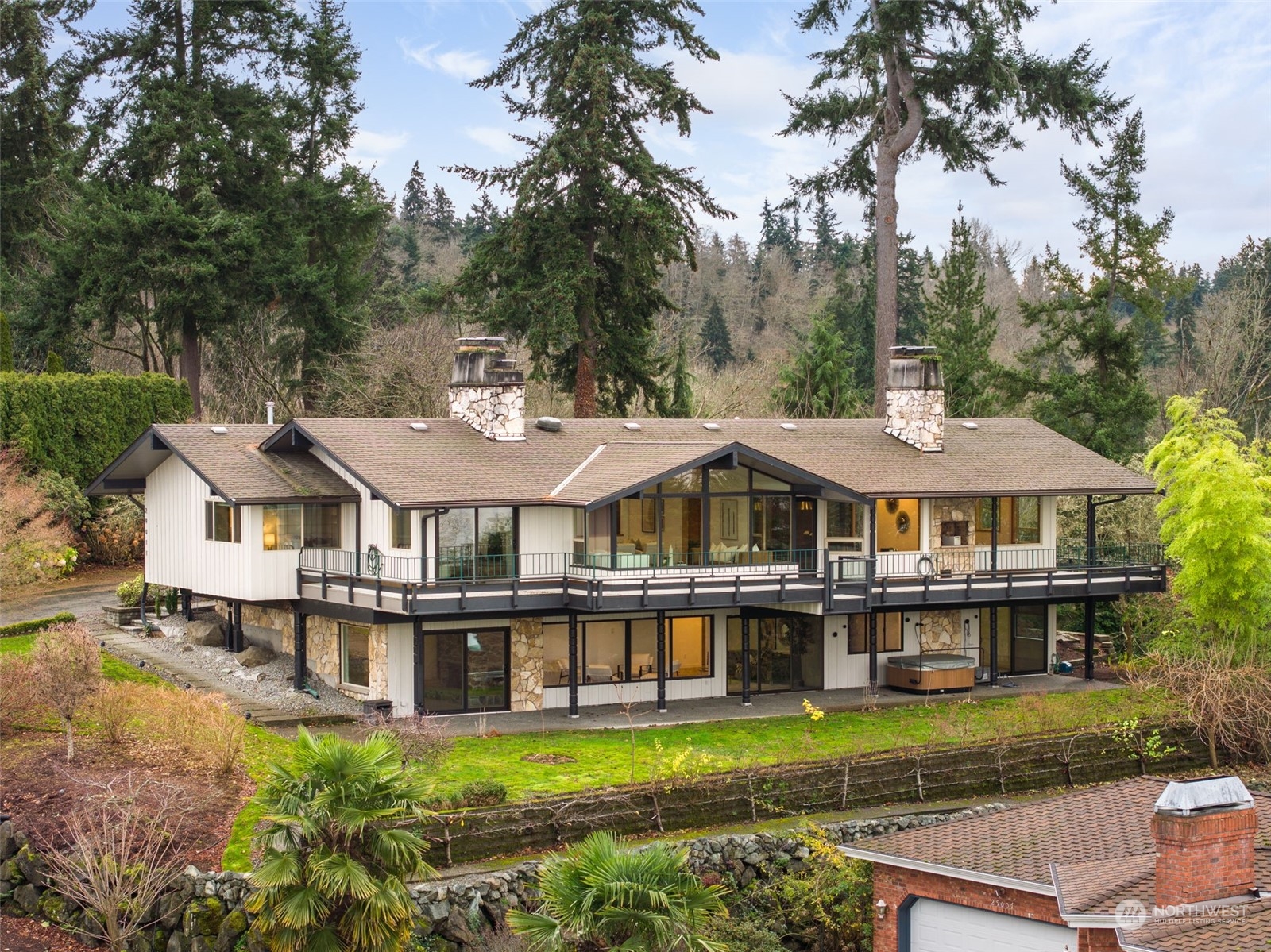 a view of a house with a garden and trees