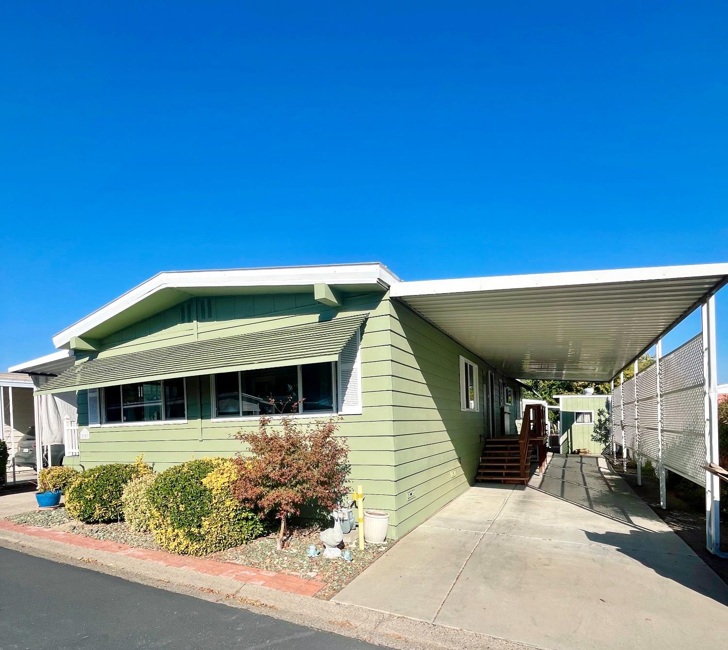 a front view of a house with a garden