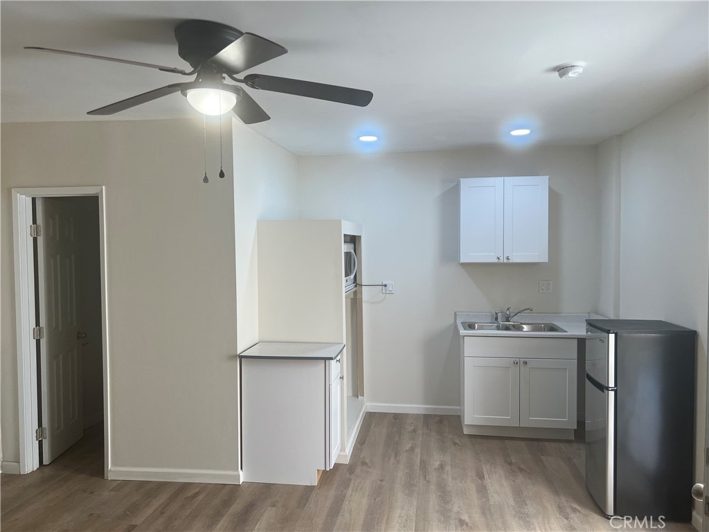 a kitchen with a refrigerator a sink and cabinets