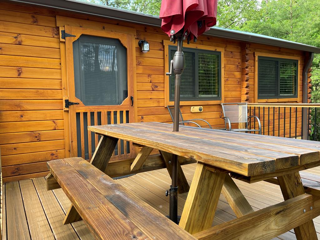 a view of deck with a table and chairs