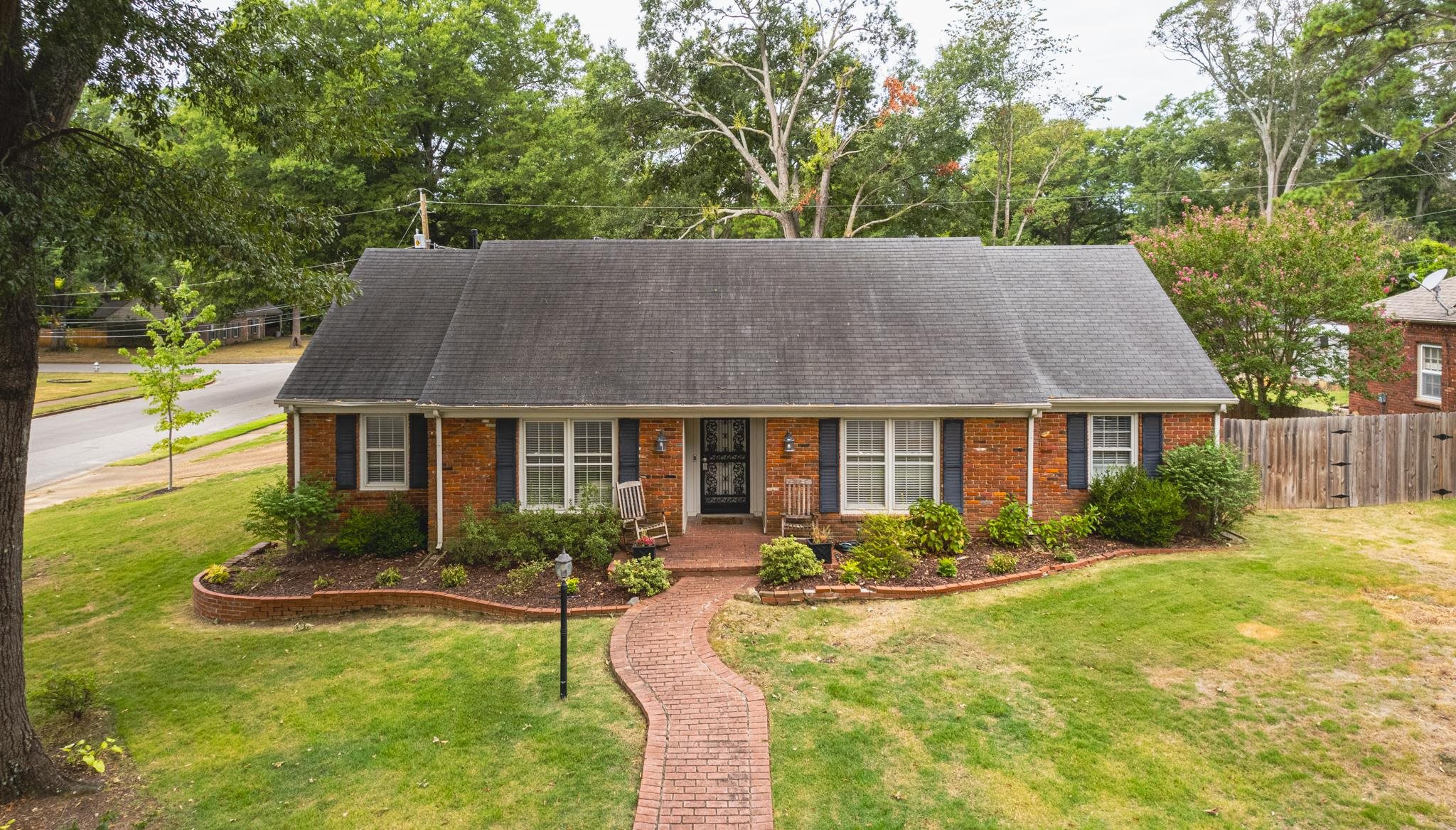 a view of house with yard and outdoor seating