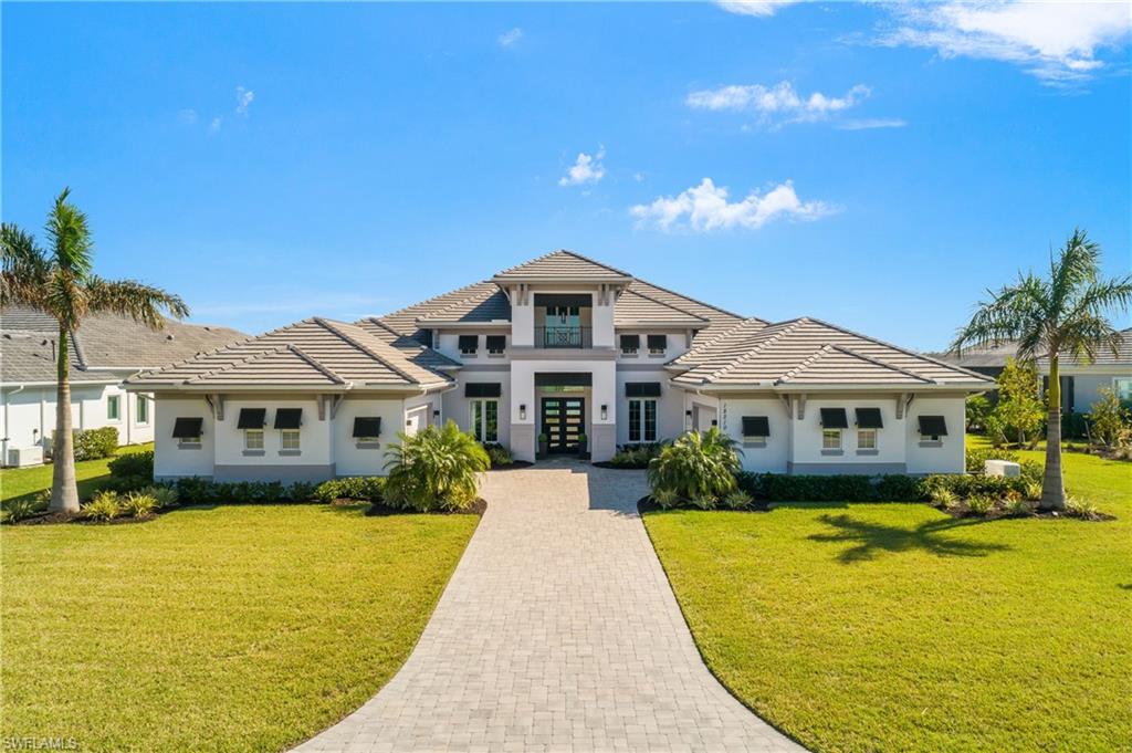 a front view of house with yard and green space