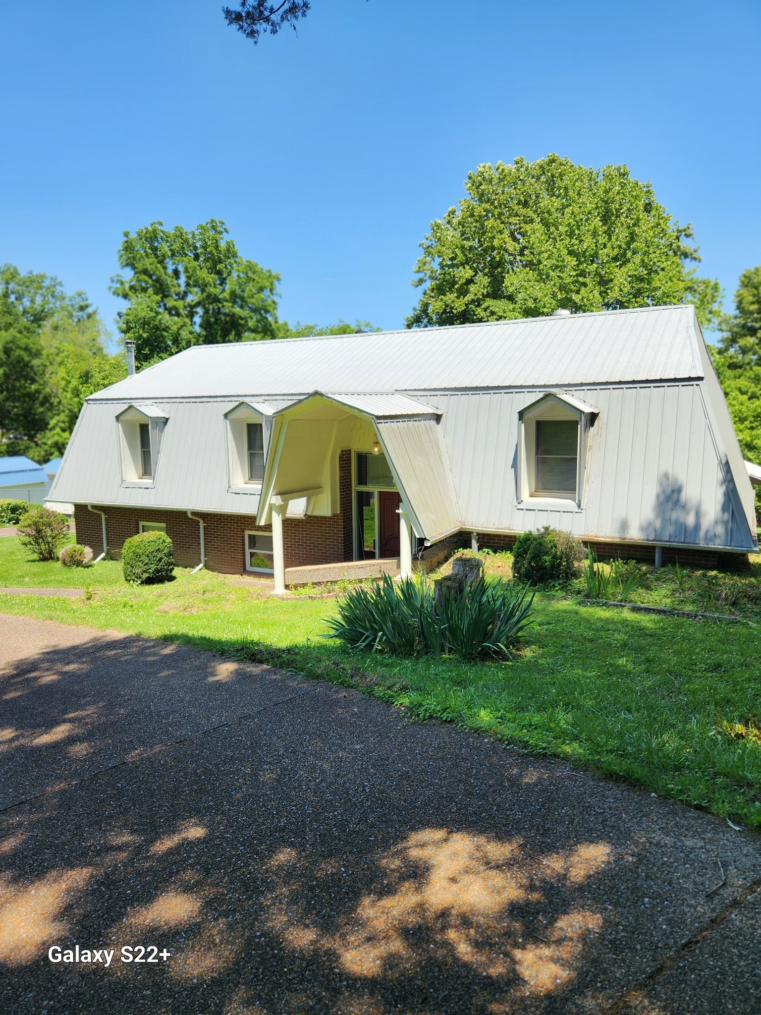 a front view of house with yard and green space