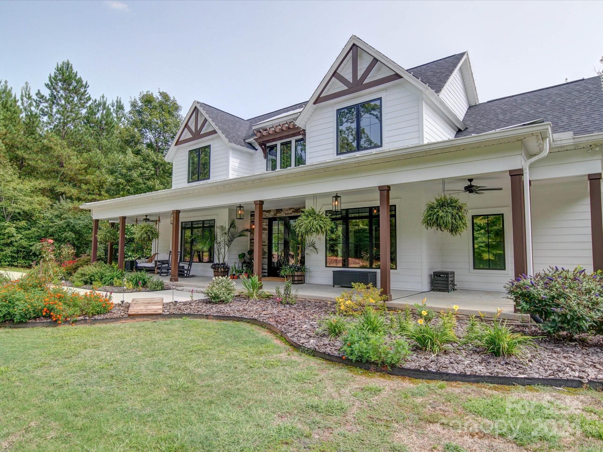 a front view of a house with garden and porch