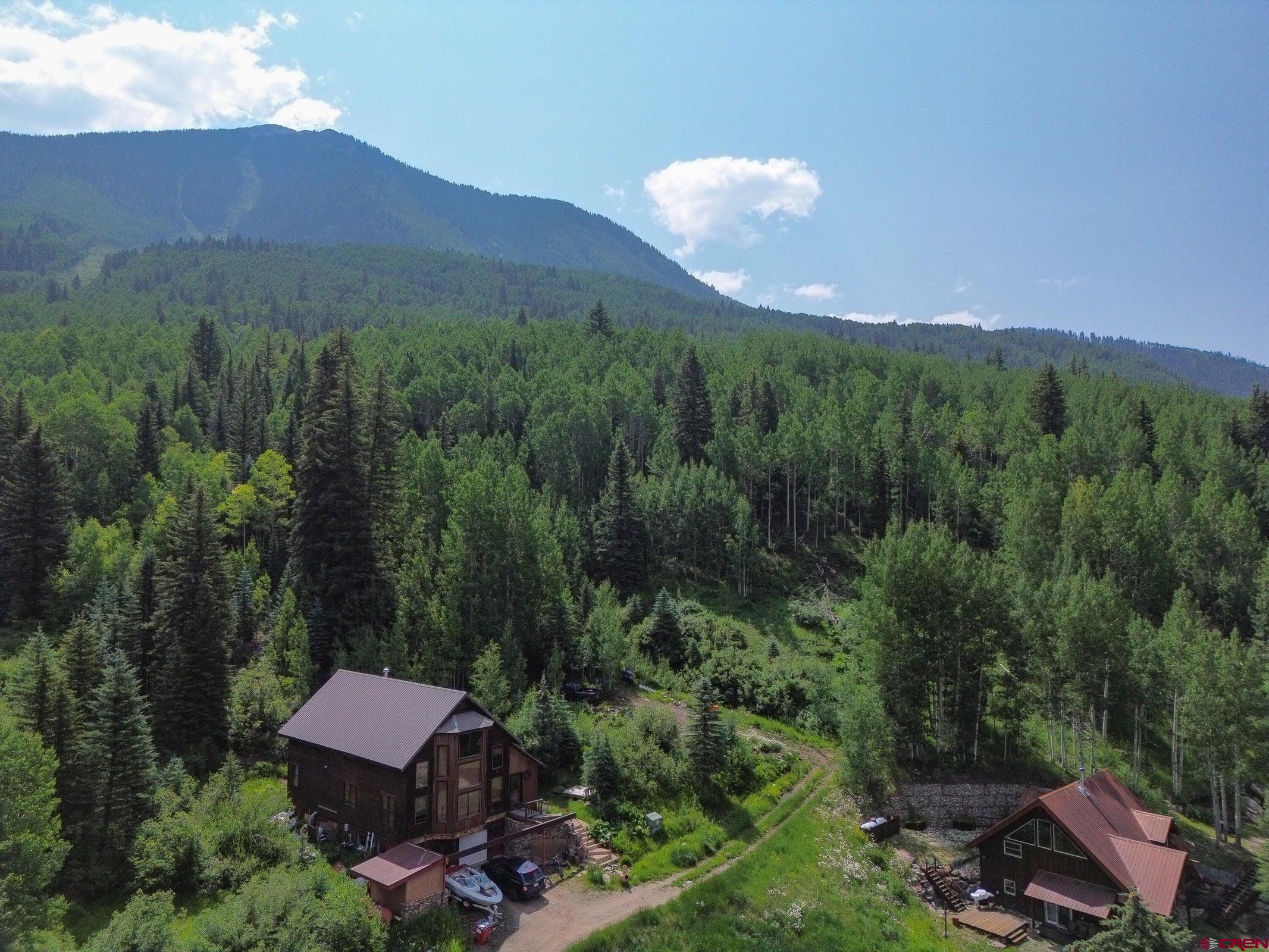 a view of a house with a yard and mountain view