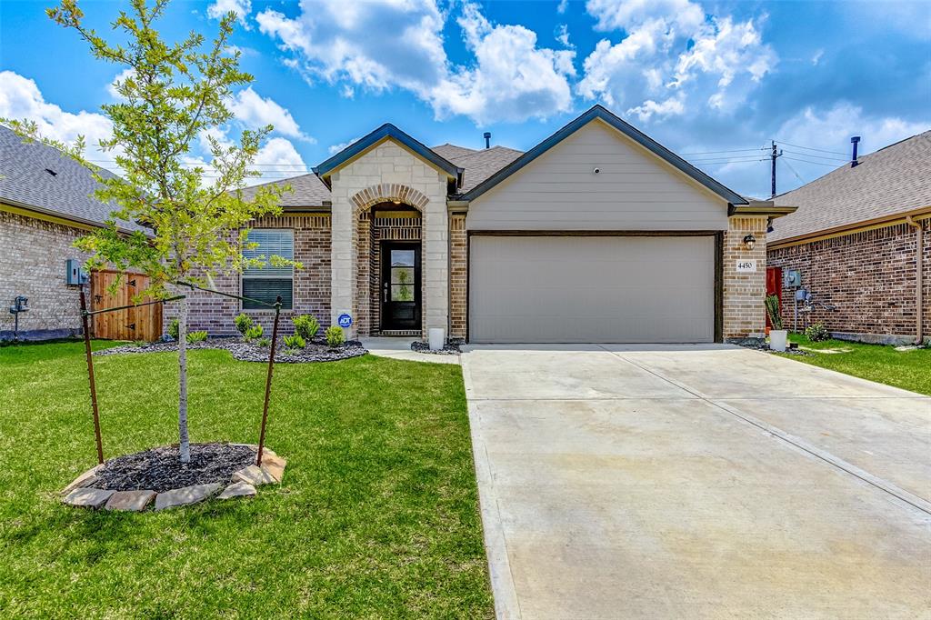 a front view of a house with a yard and garage