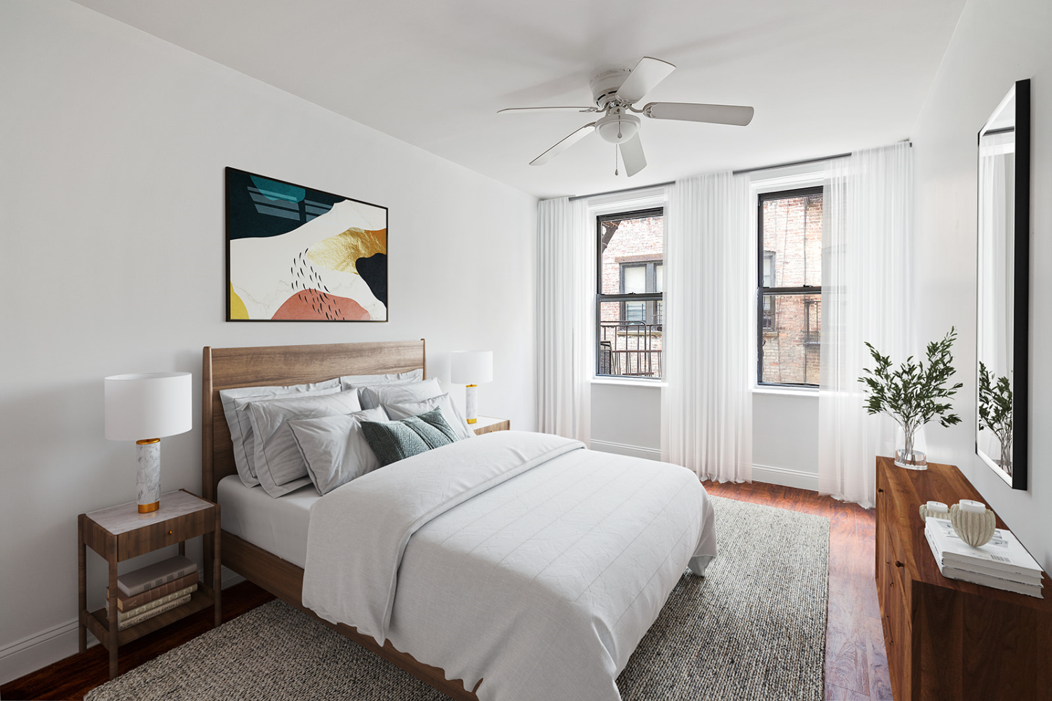 a bedroom with a bed and a potted plant