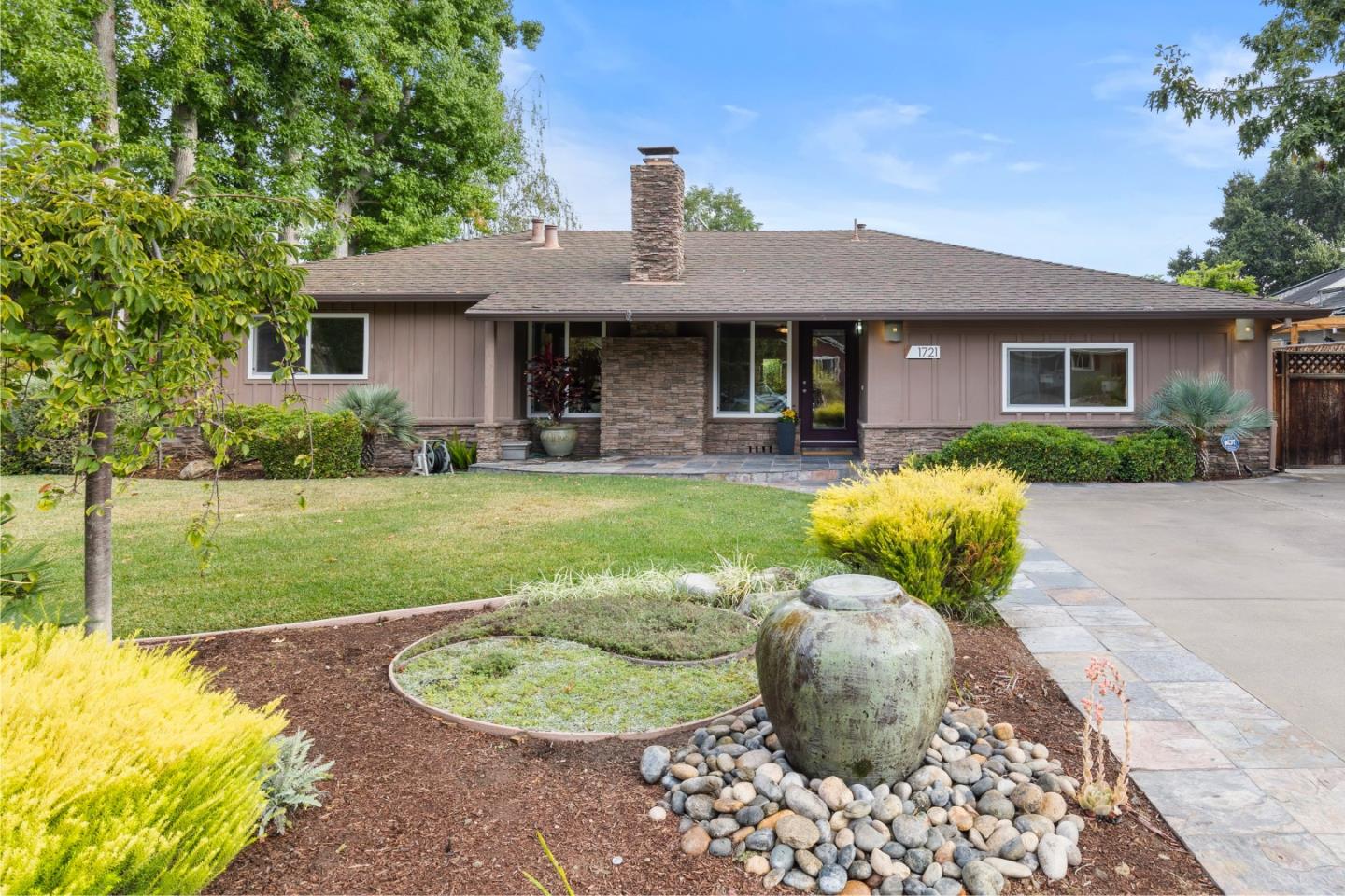 a front view of a house with a garden