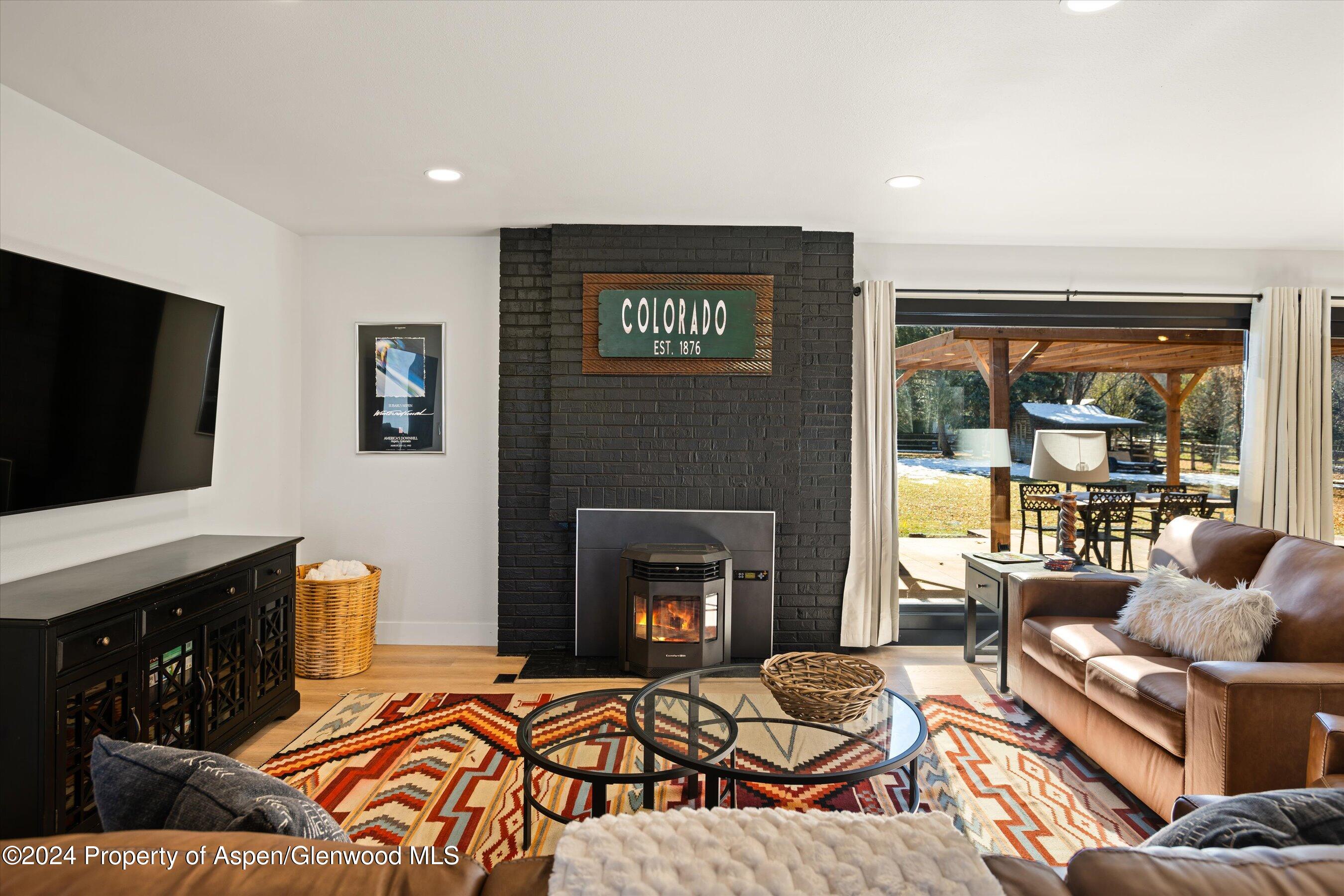 a living room with furniture fireplace and flat screen tv