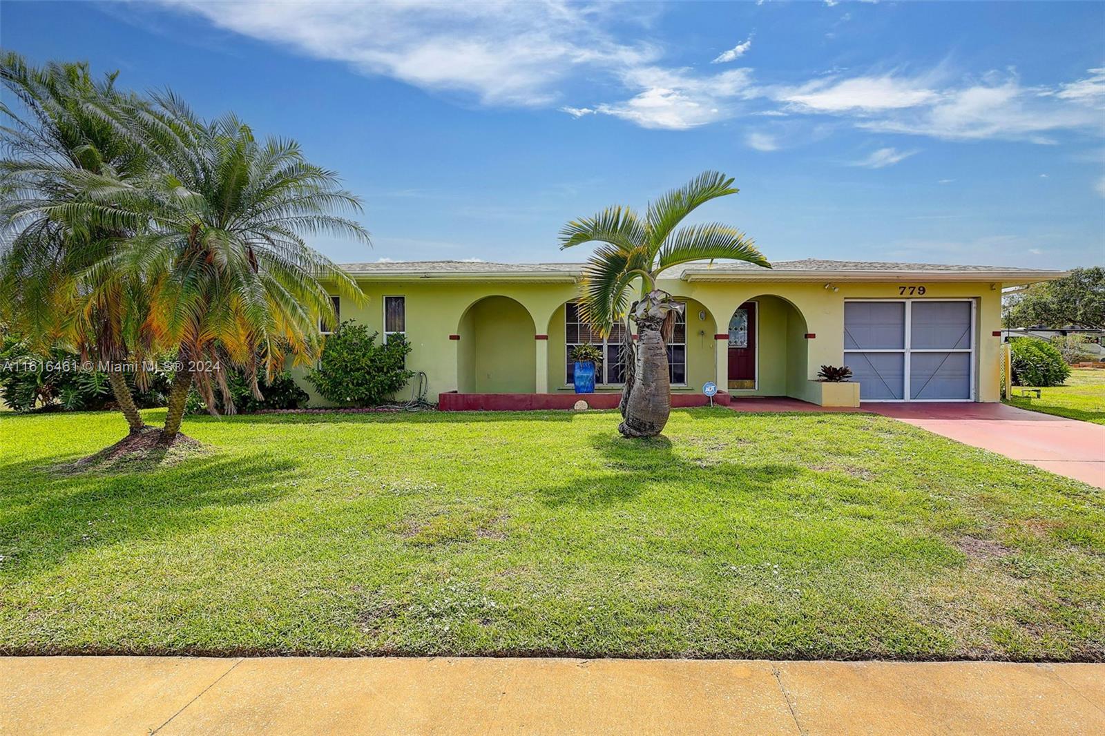 a view of a house with a backyard