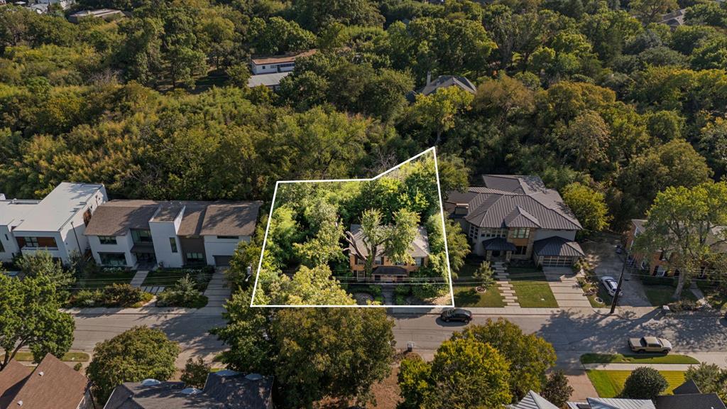 an aerial view of a house with swimming pool and garden