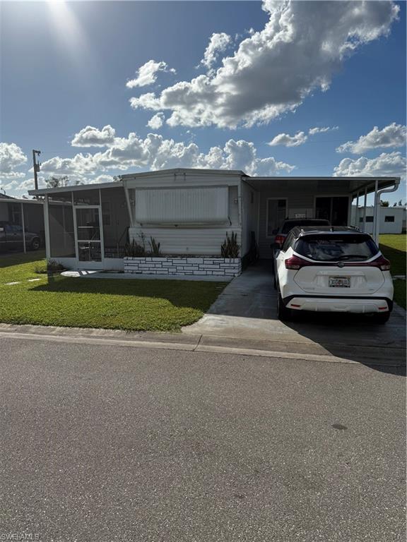 a view of a car parked in front of a house with a yard