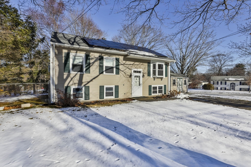 a view of a house with snow on the road