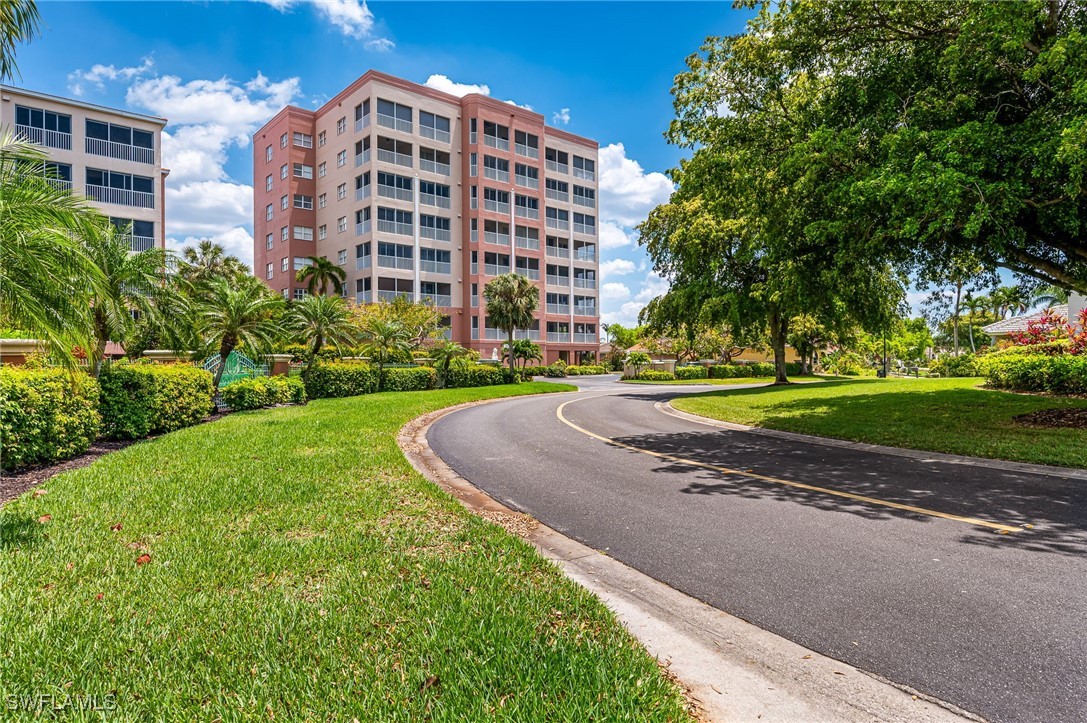 a view of a tall building next to a yard