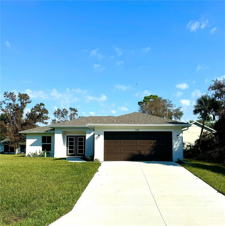 a front view of a house with a garden and yard