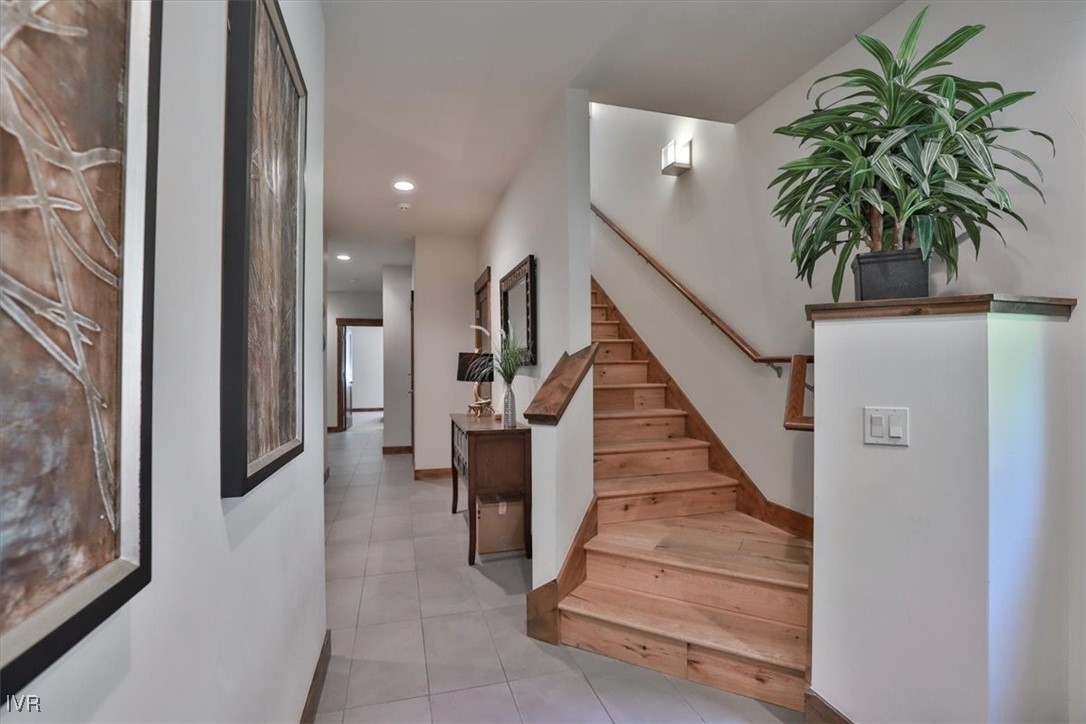 a view of entryway and hall with wooden floor