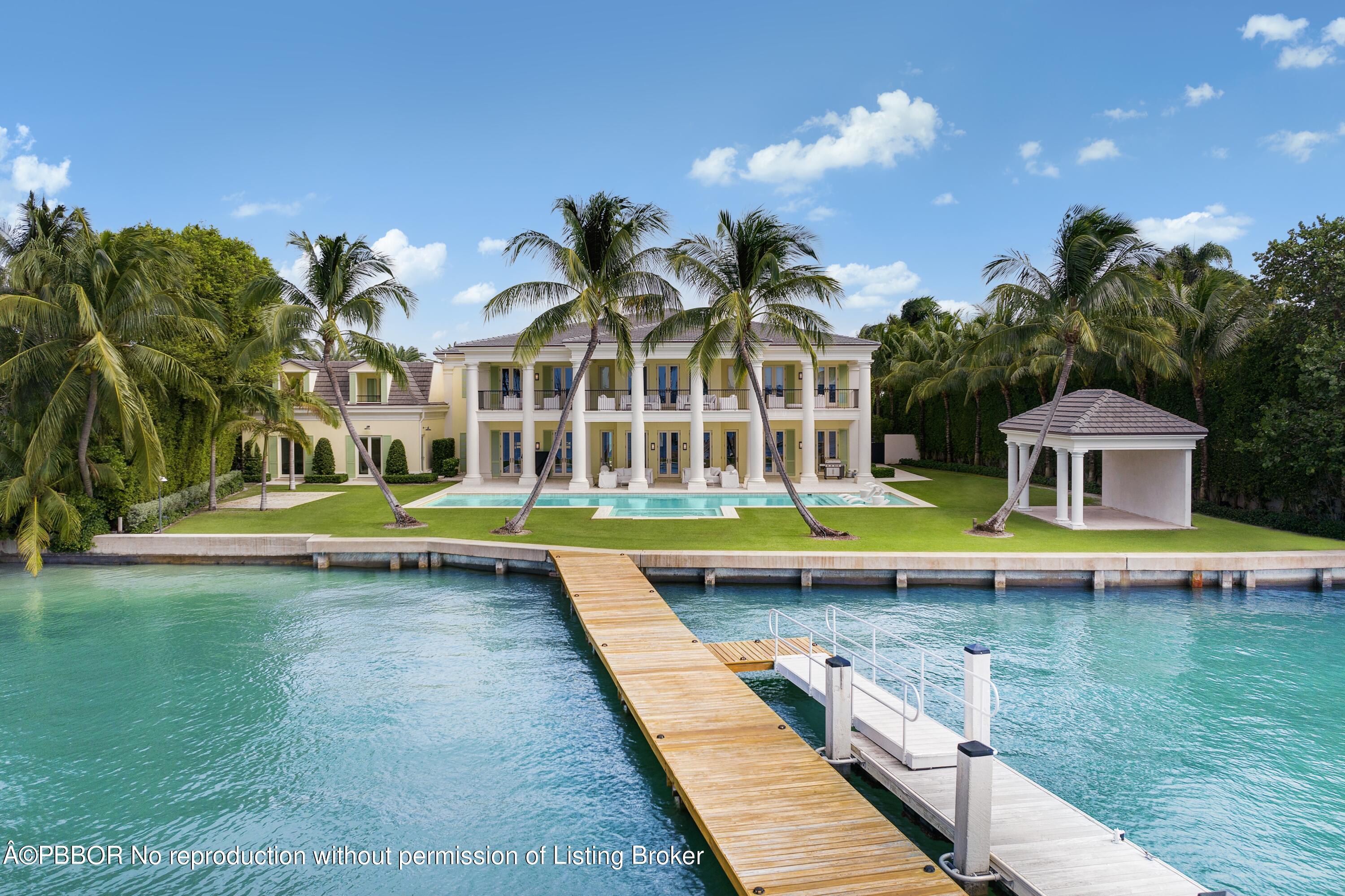 a view of a building with a large pool and a yard