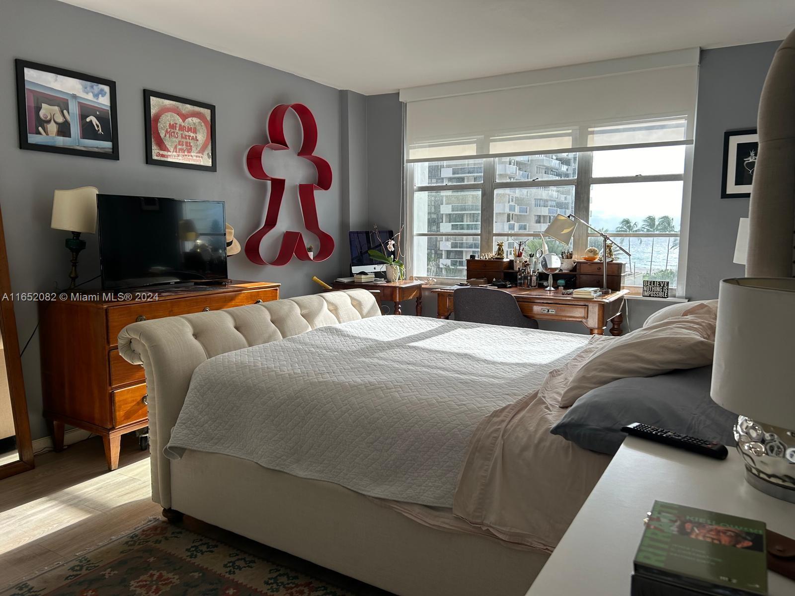 a bedroom with a bed and glass window