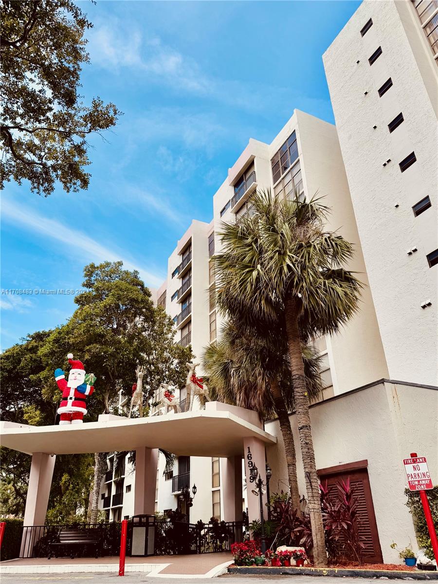 a view of building with cars parked