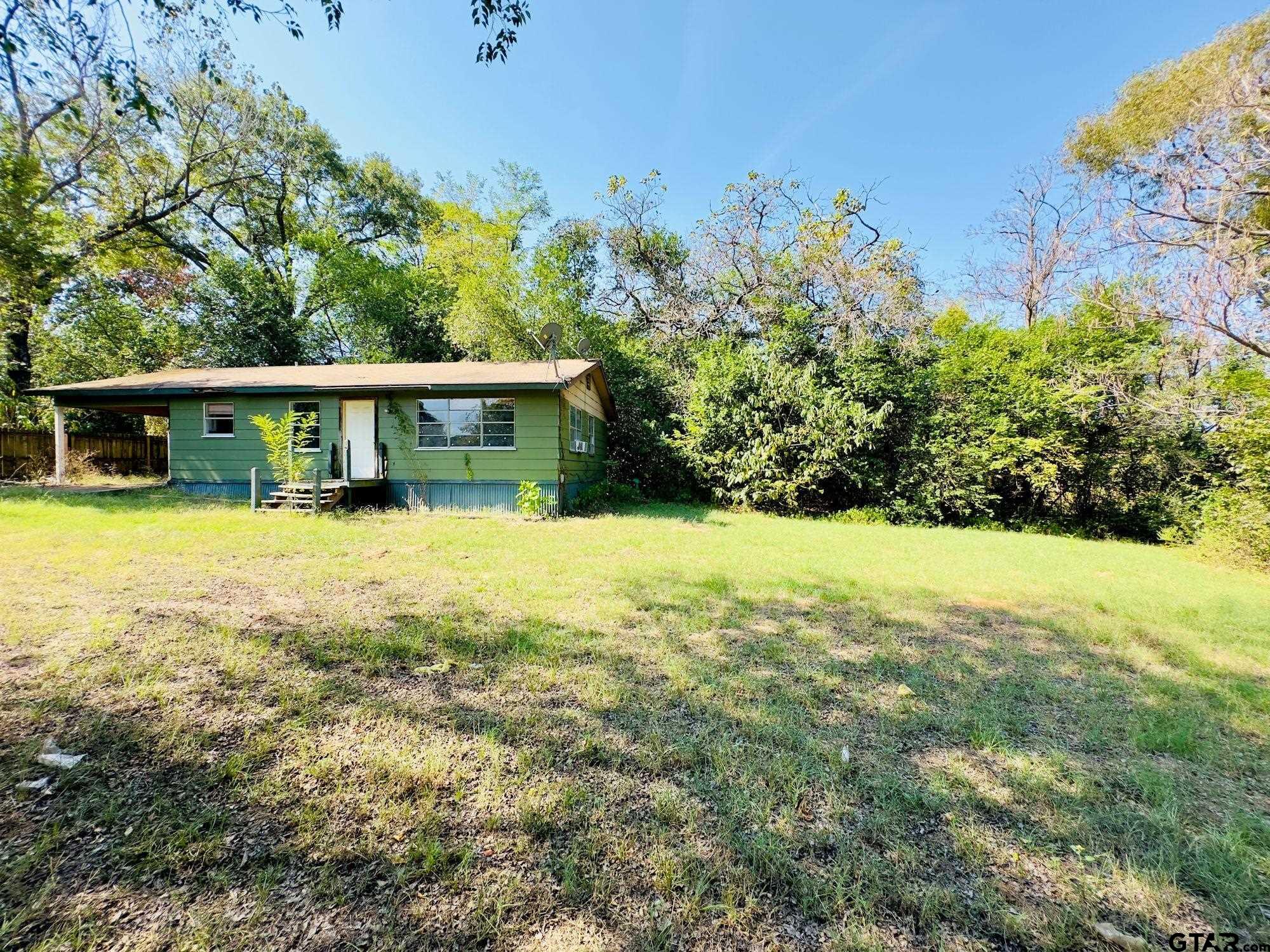 a view of a house with a yard and lake view