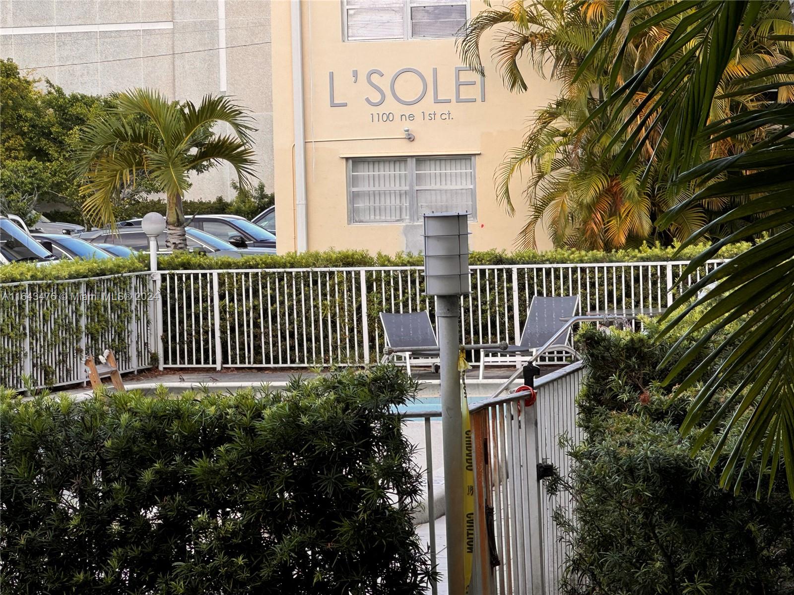 a view of a house with a small yard and plants