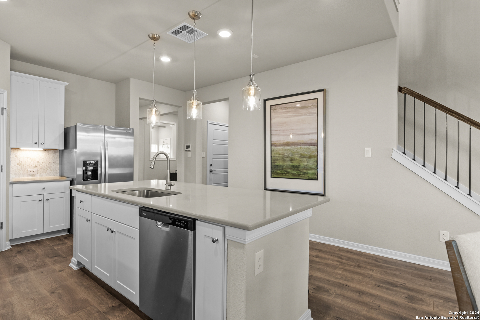 a kitchen with a sink stove and refrigerator