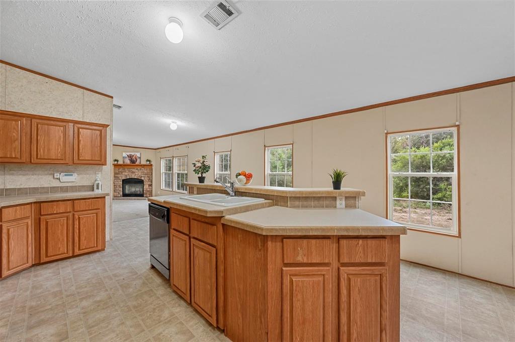 a kitchen with sink a oven and wooden cabinets