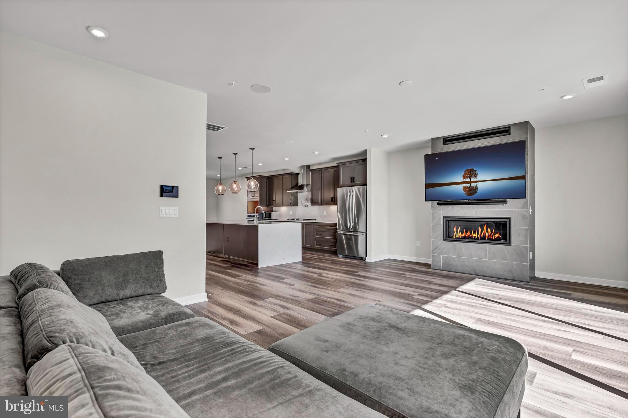 a view of kitchen and living room with wooden floor