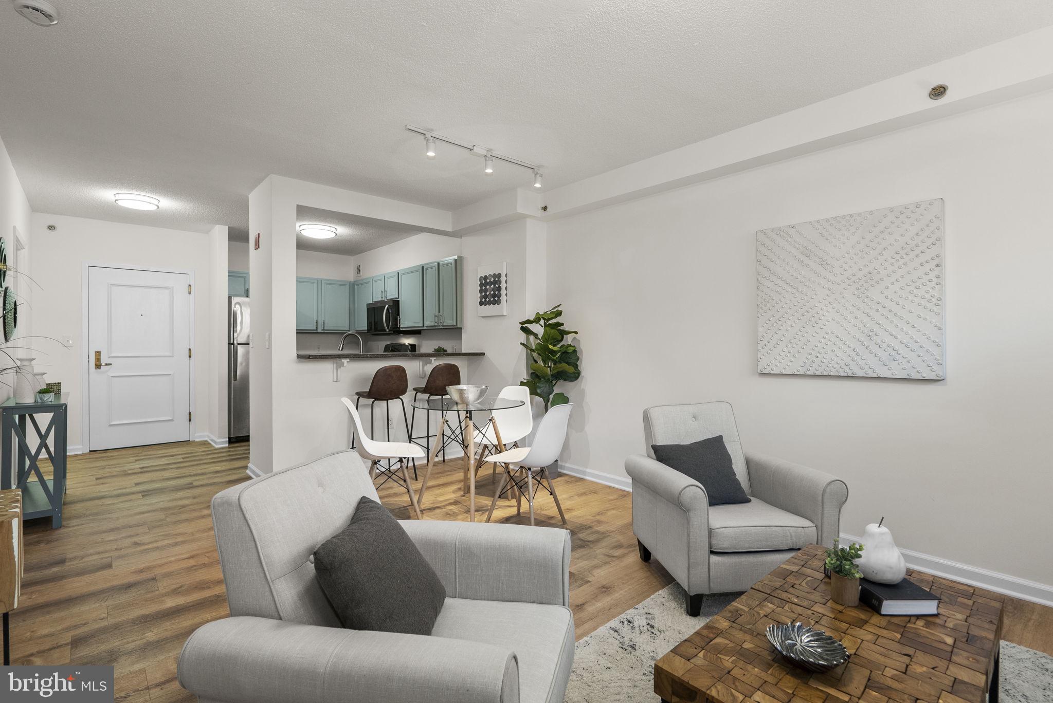 a living room with furniture and wooden floor