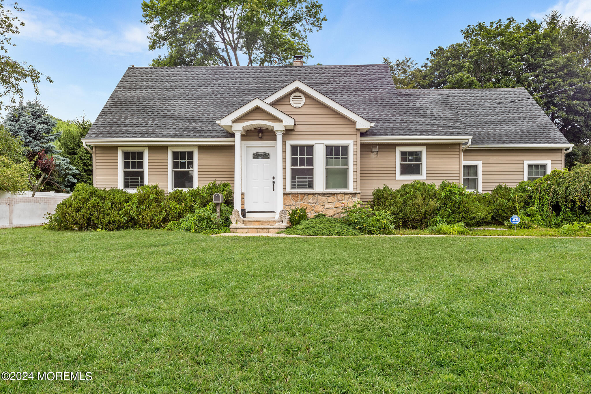 a front view of house with yard and green space