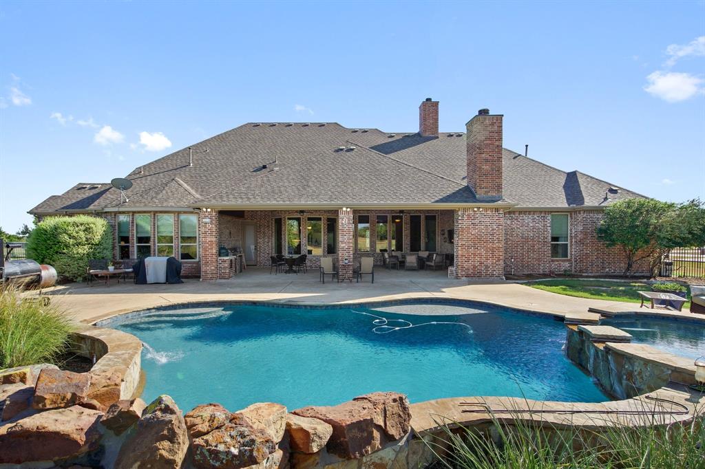 a view of a house with pool and chairs